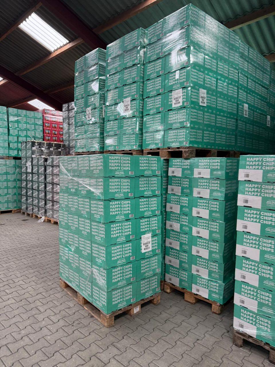 Stacked boxes of sour cream, onion and chilli crisps on pallets