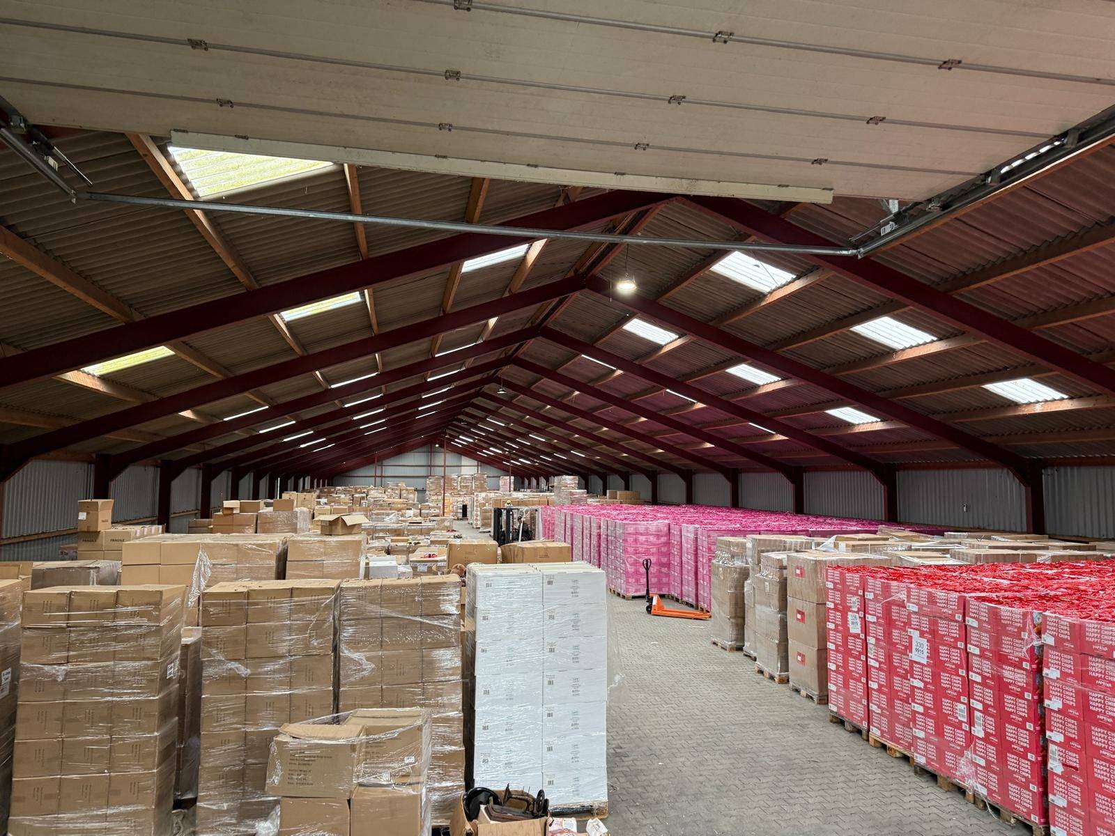 Warehouse full of pallets of food from a surplus stock