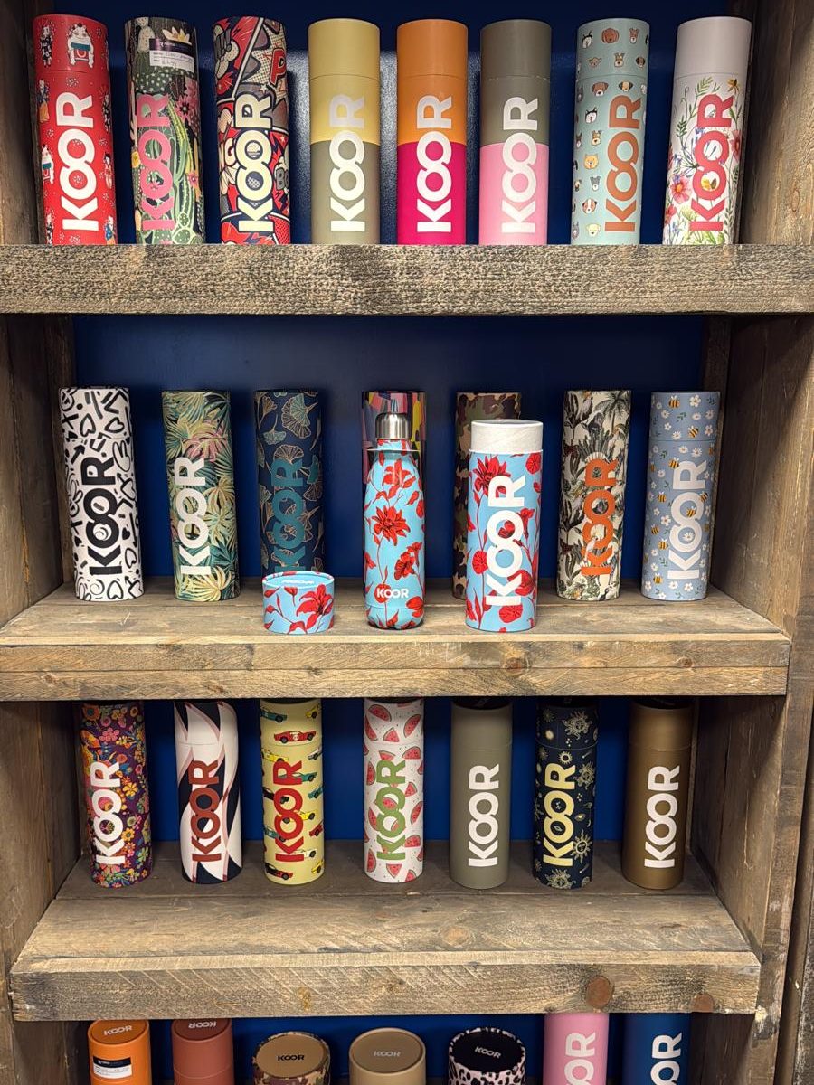 Shelf full of KOOR drinking bottles and thermos bottles in different designs