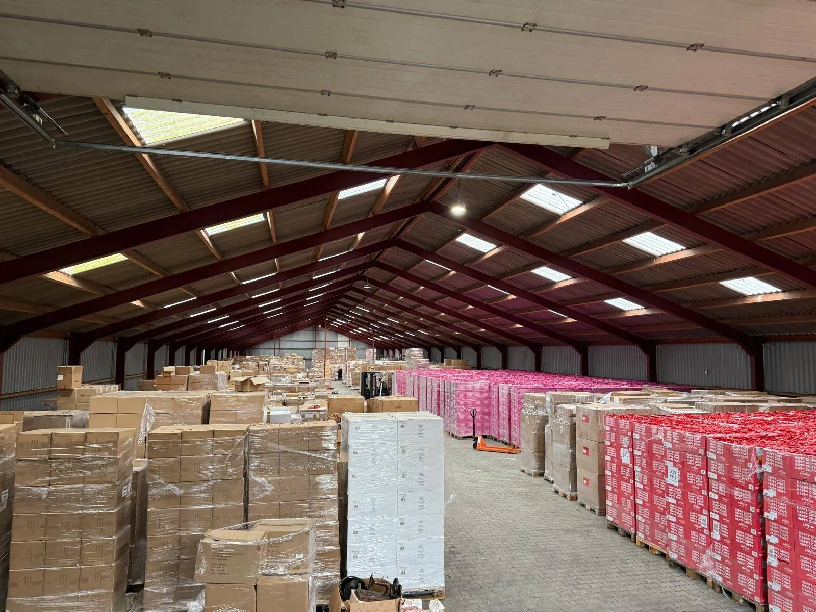 Warehouse full of pallets of crisps from the surplus stock, ready for transport